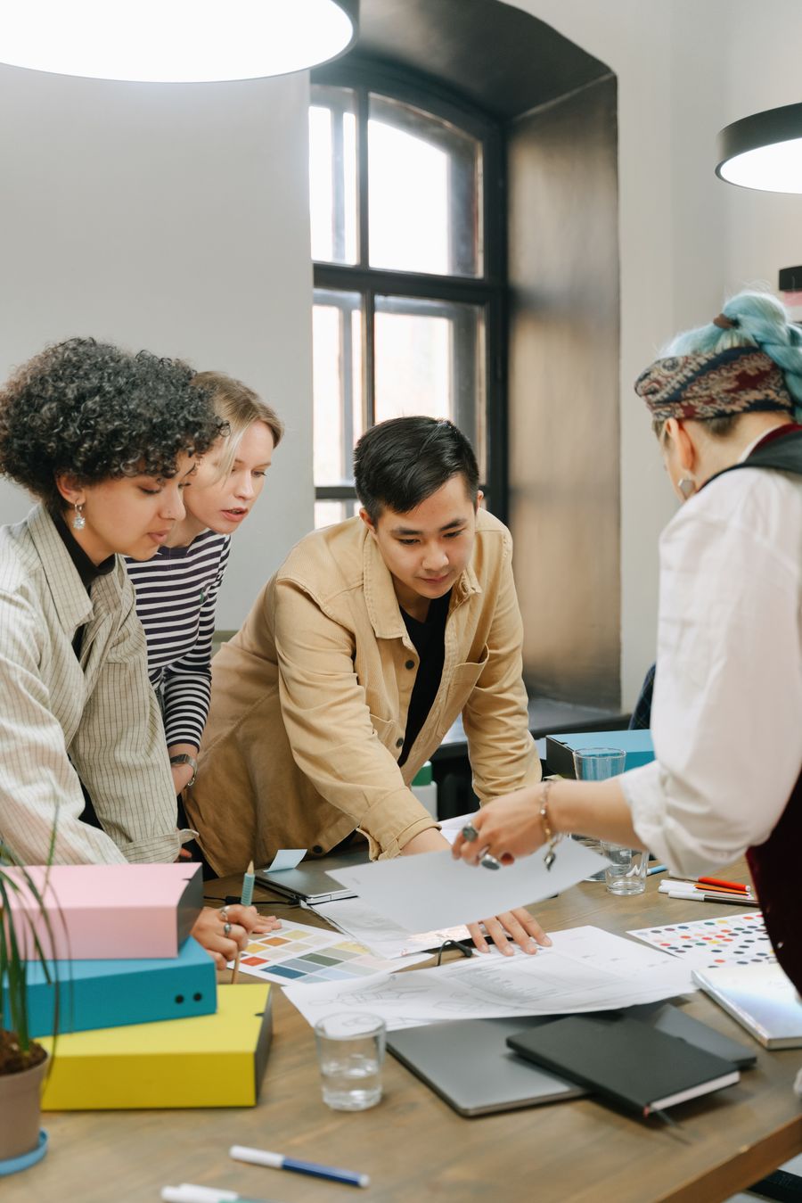 A team reviewing design work together at a table.